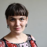 Anja Homburg A photo of Communications and Promotions Officer Anja Homburg. A woman with dark brown hair worn up with a straight fringe. She is looking at the camera and smiling with a closed mouth.