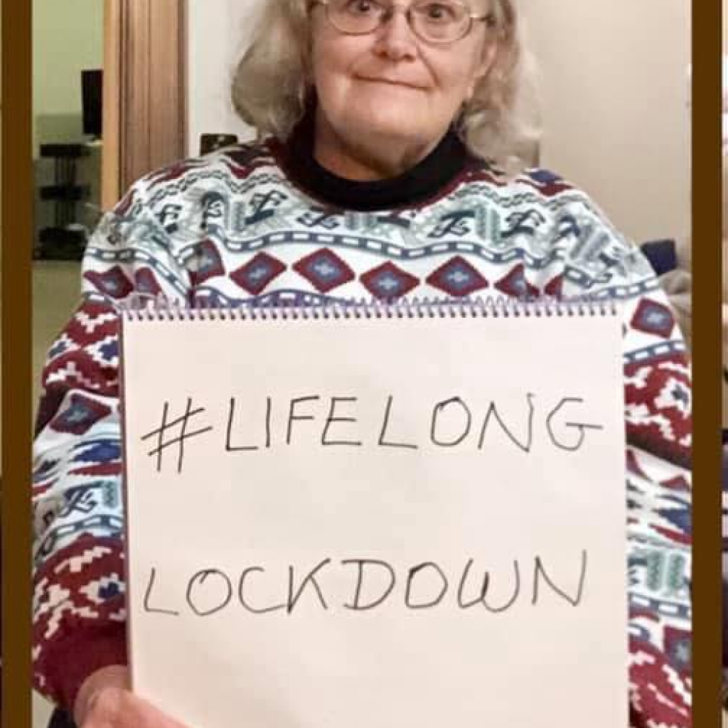 Woman holding a #LifelongLockdown sign