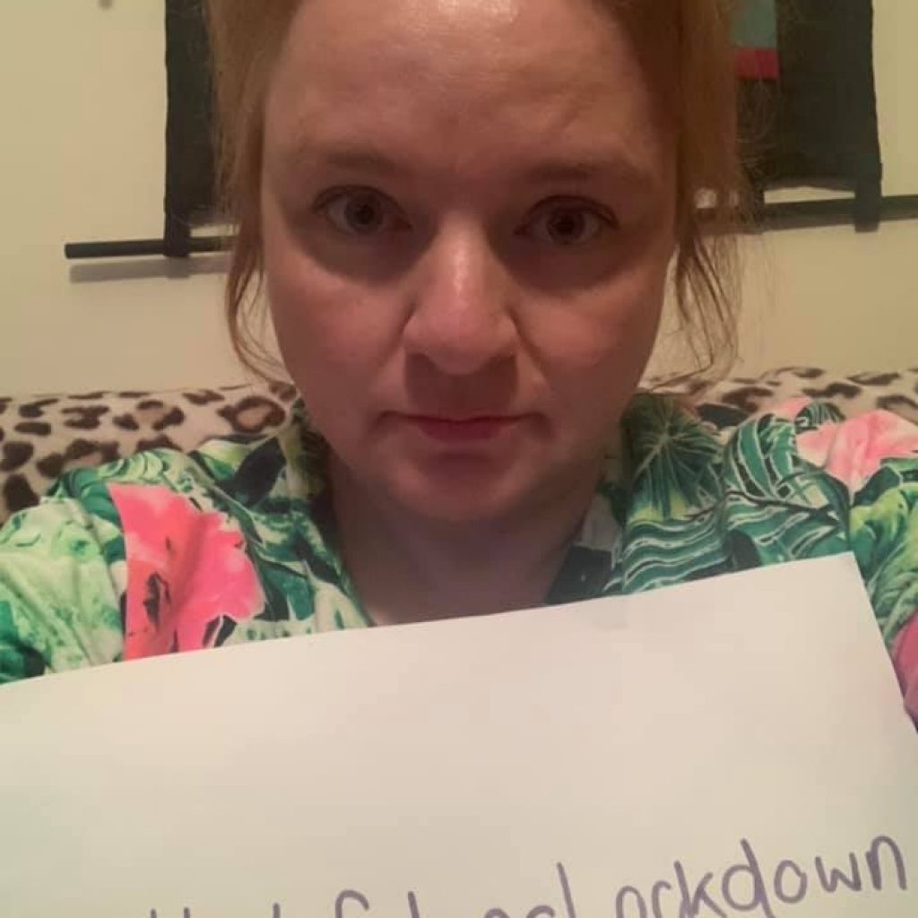 Woman holding a sign saying #LifelongLockdown