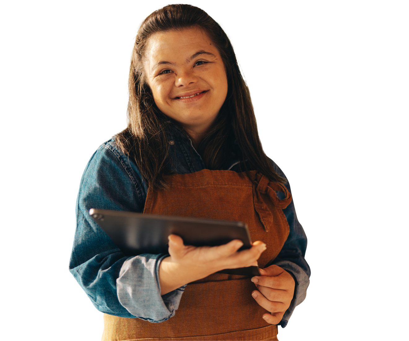 A person with Downs syndrome who has light skin and long dark hair pulled back behind them. They're wearing a brown smock, with a blue denim jacket, and are smiling towards the camera, holding an iPad close to their body. Behind them is a vivid red background that fades towards white, and the words: disability pride and culture."